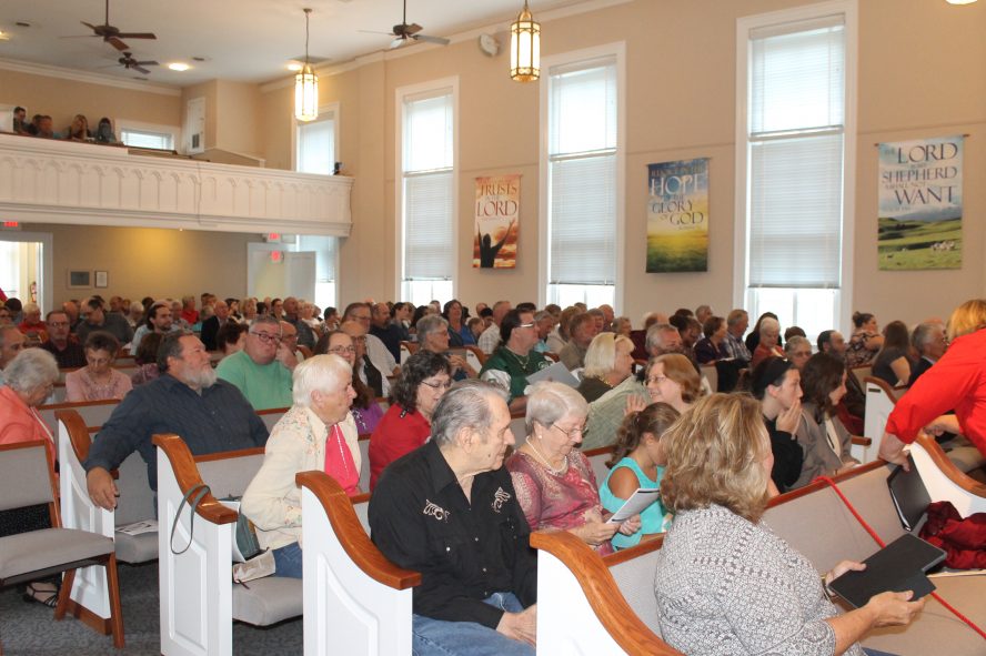 Congregation during a church service seen from the front.