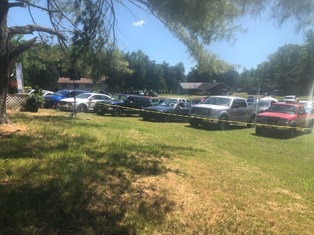Line of cars parked on the grass